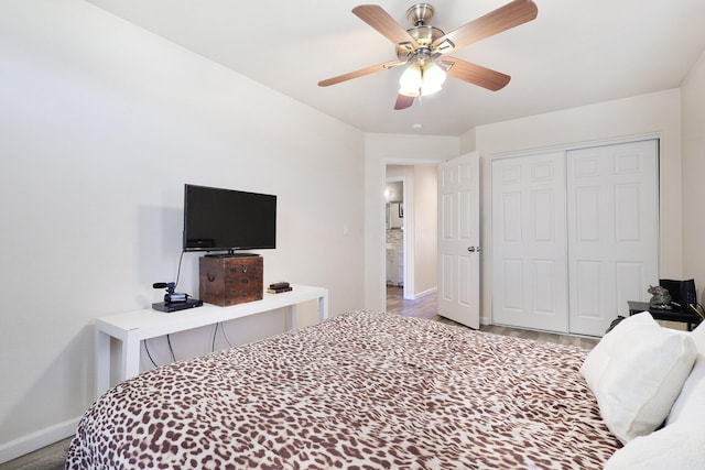 bedroom featuring wood-type flooring, ceiling fan, and a closet