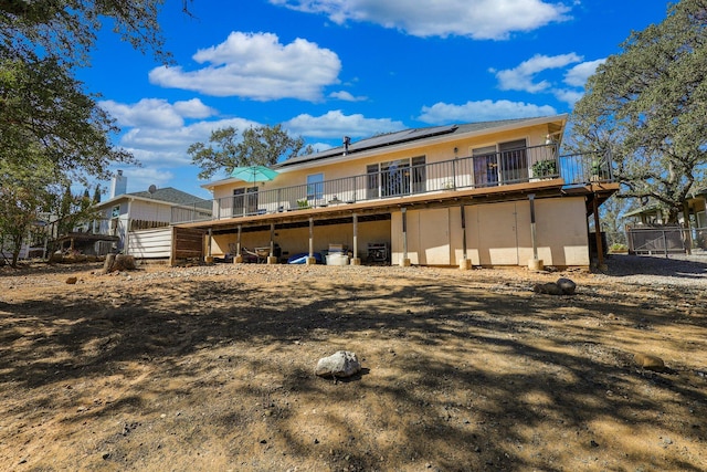 back of property featuring a deck