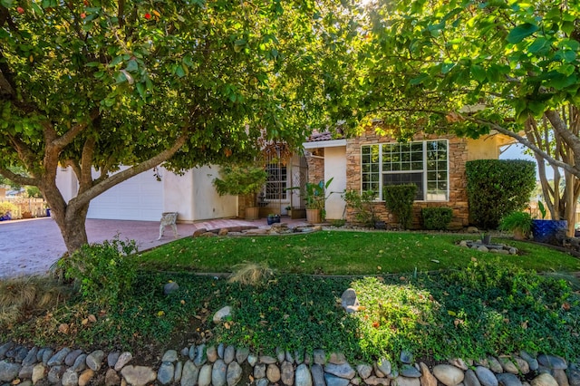 view of property hidden behind natural elements with a garage