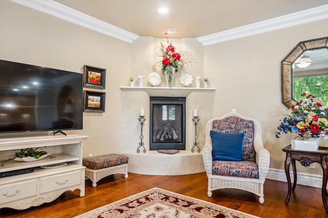 sitting room featuring wood-type flooring and ornamental molding