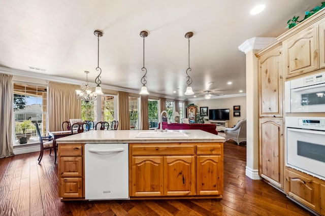 kitchen featuring a kitchen island with sink, dark wood-type flooring, decorative light fixtures, sink, and ornamental molding