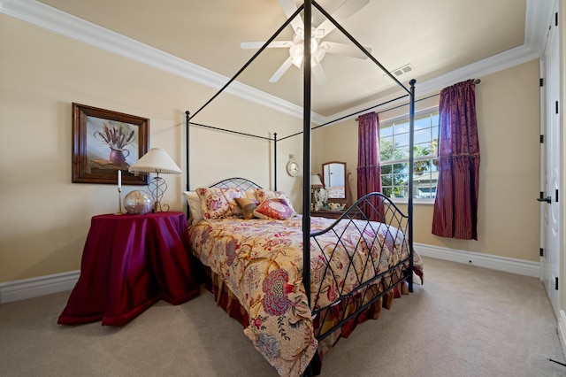 carpeted bedroom featuring ceiling fan and crown molding