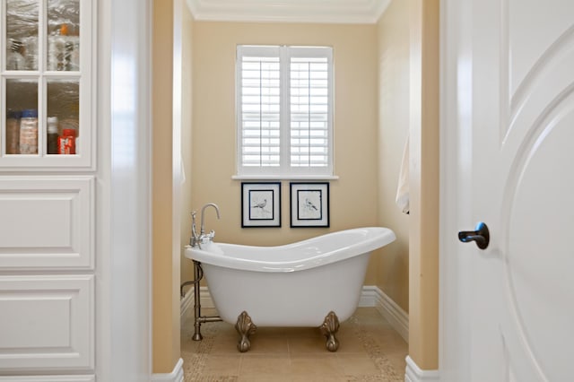 bathroom with crown molding, a bath, and tile patterned floors