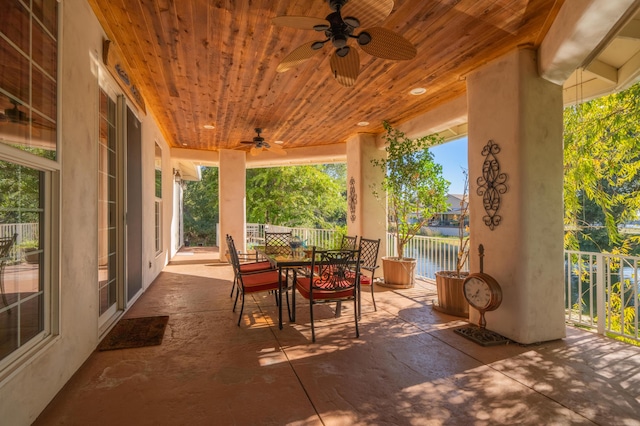 view of patio / terrace with a water view and ceiling fan