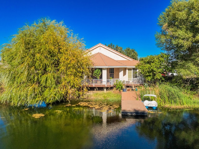 back of property featuring a water view