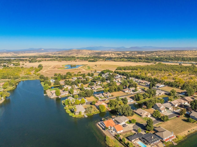 aerial view featuring a water and mountain view