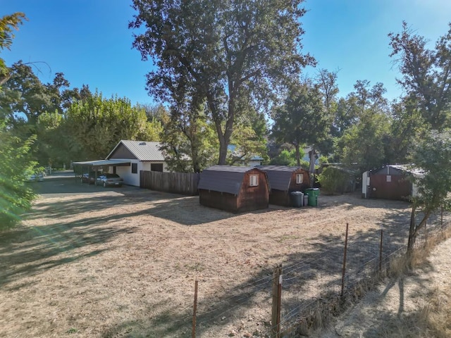 view of front facade featuring a carport and a shed