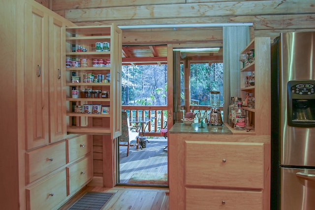 doorway to outside with light wood-type flooring