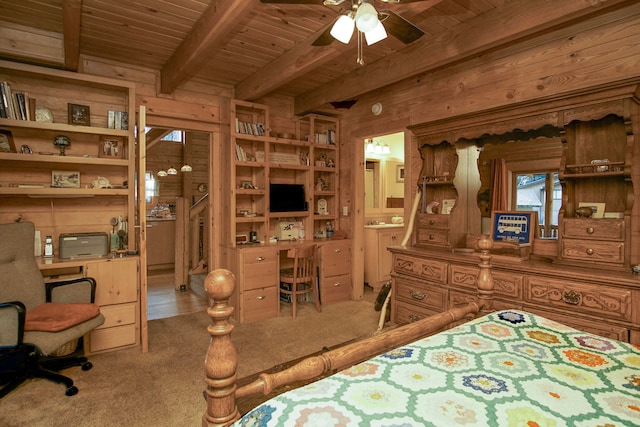 bedroom with connected bathroom, beamed ceiling, wood ceiling, and wood walls