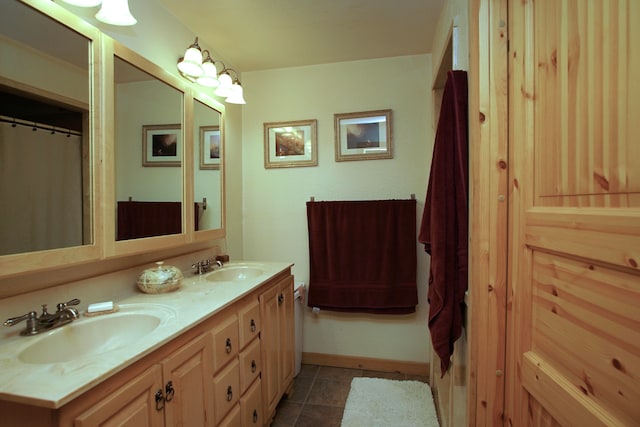 bathroom with tile patterned floors and vanity