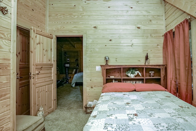 bedroom with wood walls and carpet floors