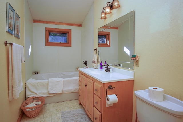 bathroom with a bath, vanity, and toilet