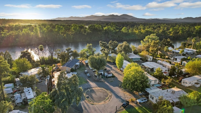 drone / aerial view with a water and mountain view