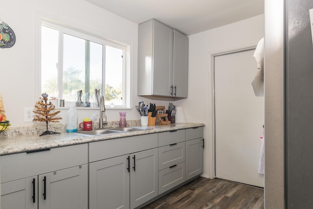 kitchen with gray cabinets, dark hardwood / wood-style floors, and sink