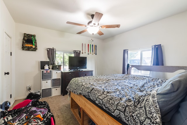 bedroom with carpet flooring, multiple windows, and ceiling fan