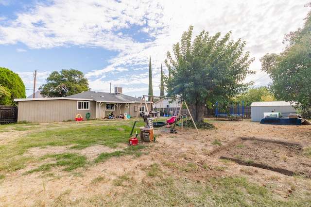 view of yard featuring a playground and a storage unit