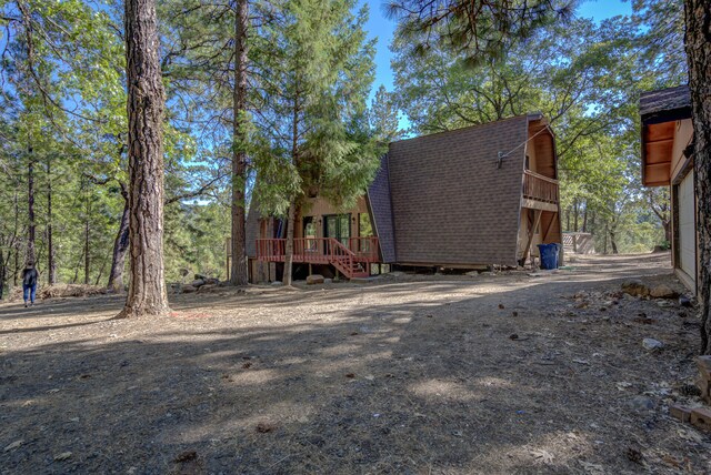 rear view of house with a wooden deck