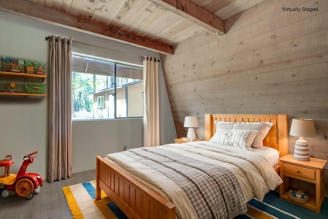 bedroom featuring hardwood / wood-style flooring, beam ceiling, and wood ceiling