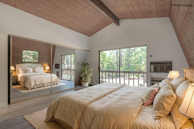 bedroom with access to outside, beamed ceiling, hardwood / wood-style floors, a wall unit AC, and wood ceiling