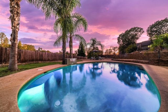 view of pool at dusk