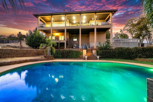 view of pool at dusk