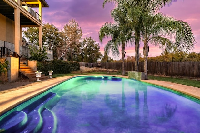 view of pool at dusk