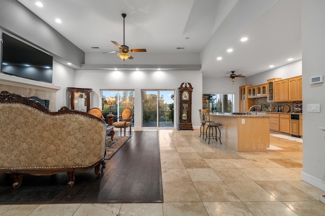 interior space featuring a fireplace, light wood-type flooring, and ceiling fan