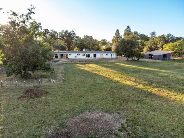 exterior space with a rural view and a front lawn