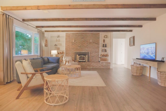 living room with wood-type flooring, beam ceiling, and a wood stove