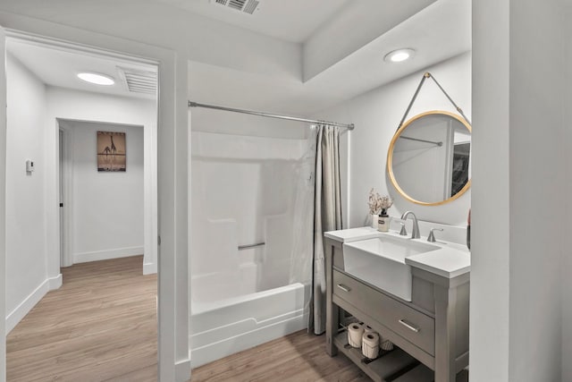 bathroom featuring shower / tub combo, vanity, and hardwood / wood-style floors