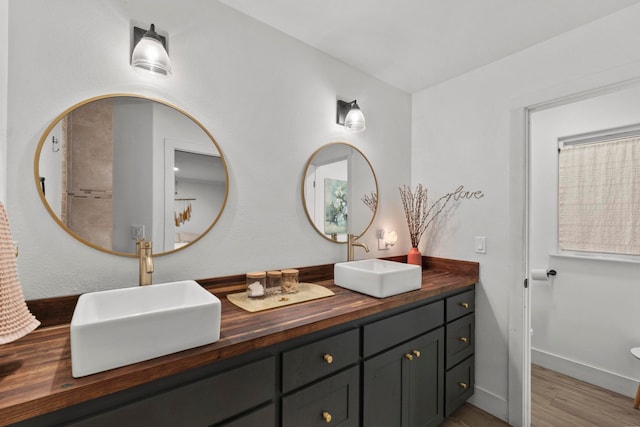 bathroom with hardwood / wood-style floors and vanity