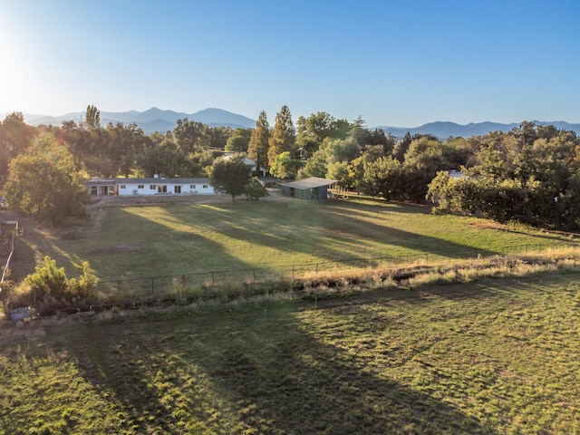 view of yard featuring a rural view and a mountain view