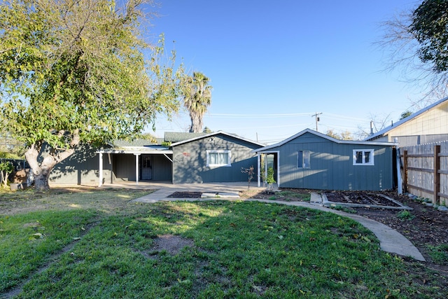 rear view of house with a yard and a patio