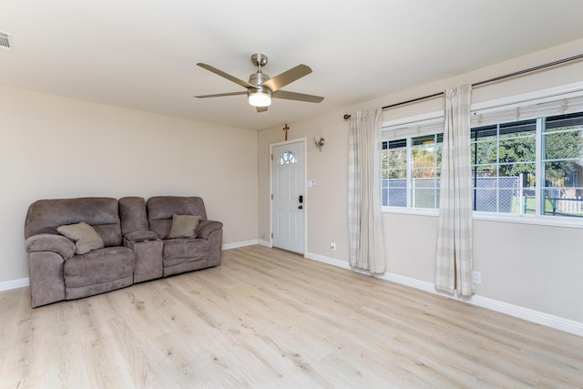 living room featuring light wood-type flooring and ceiling fan