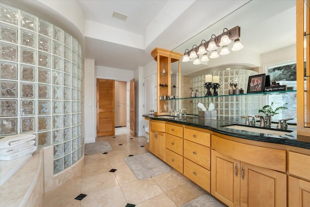 bathroom with vanity, tasteful backsplash, and tile patterned floors