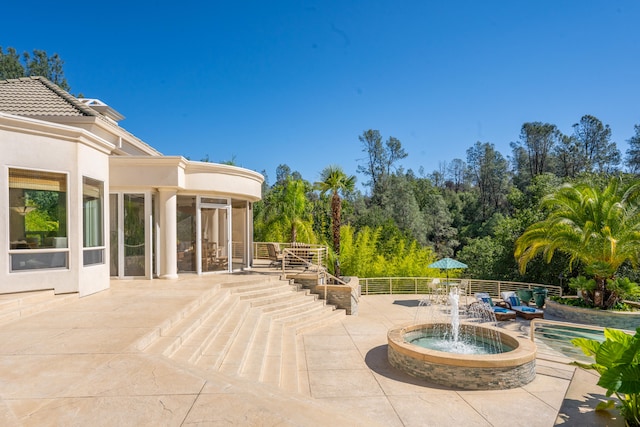 view of patio / terrace featuring pool water feature