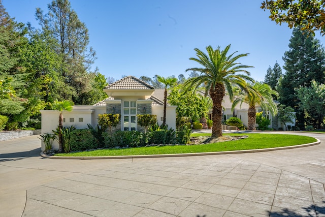 mediterranean / spanish-style home featuring a front lawn