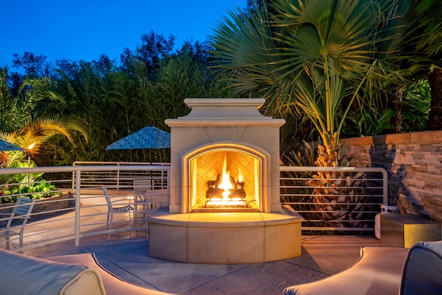 view of patio with exterior fireplace