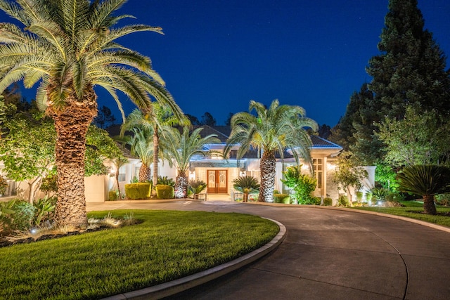 mediterranean / spanish house featuring a lawn