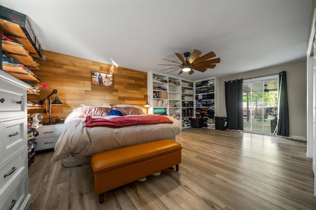 2648 Tremonto Rd, Anderson, CA 96007 - bedroom with access to exterior, wooden walls, a ceiling fan, and wood finished floors