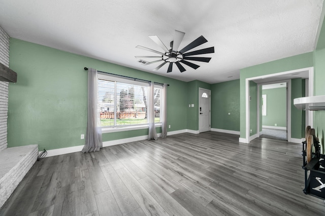 2648 Tremonto Rd, Anderson, CA 96007 - unfurnished living room featuring wood finished floors, a brick fireplace, a ceiling fan, and baseboards