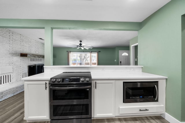 2648 Tremonto Rd, Anderson, CA 96007 - kitchen with light countertops, white cabinets, wood finished floors, and appliances with stainless steel finishes