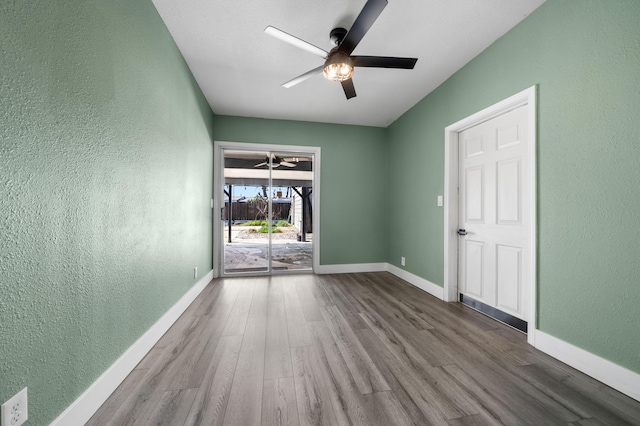 2648 Tremonto Rd, Anderson, CA 96007 - spare room with baseboards, wood finished floors, a ceiling fan, and a textured wall