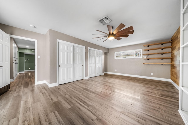 2648 Tremonto Rd, Anderson, CA 96007 - unfurnished bedroom with visible vents, two closets, baseboards, and wood finished floors