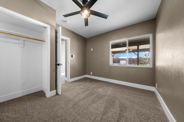 2648 Tremonto Rd, Anderson, CA 96007 - unfurnished bedroom with a closet, ceiling fan, baseboards, and carpet floors