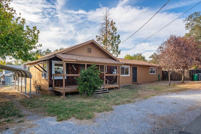 view of front of house featuring a carport and a deck