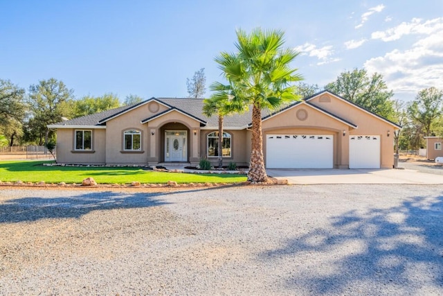 ranch-style home featuring a front yard and a garage