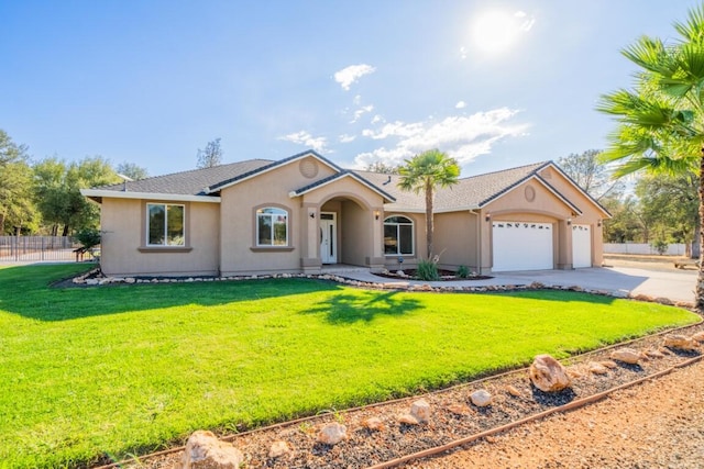 single story home with a front yard and a garage