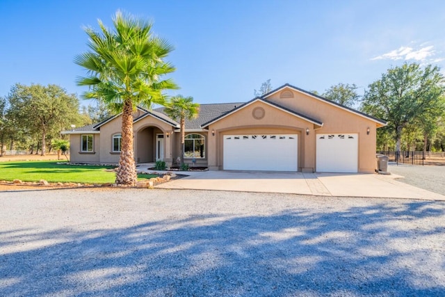 ranch-style house featuring a garage and a front lawn