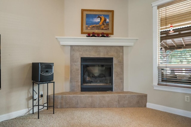 room details with a tiled fireplace and carpet flooring